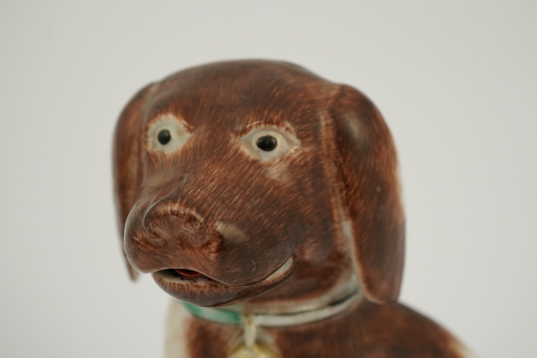 A Chinese export enamelled porcelain model of a seated spaniel, Qianlong period